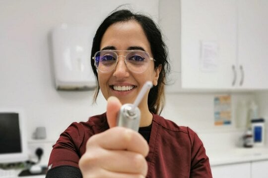 Dr Kiren in our dental surgery in London, about to receive an Invisalign patient