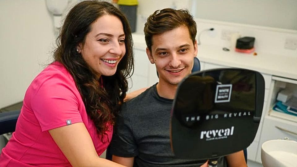 Dentist showing patient results of laser teeth whitening at Whites Dental in London